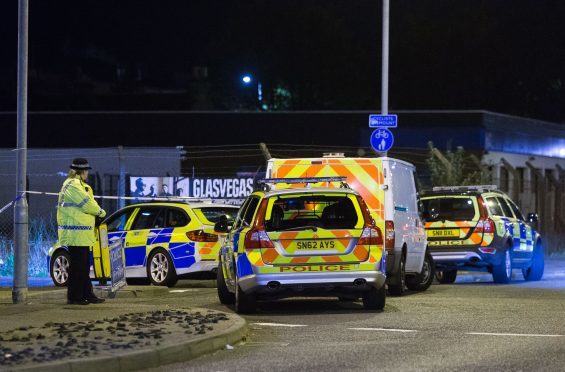 Police vehicles at the scene of the tragedy.