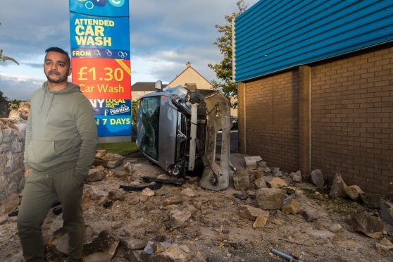 Garage owner Nazim Ali with the stricken vehicle.