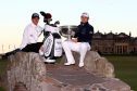Tyrrell Hatton of England holds the trophy aloft with his caddie Chris Rice on the Swilken Bridge on the 18th hole after winning the Alfred Dunhill Links Championship at The Old Course last year.