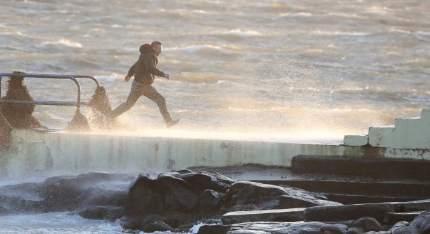 Dare devils run out to a diving board Salthill, Galway, as Hurricane Ophelia batters the UK and Ireland earlier this week.