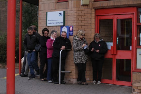 An early morning queue outside Broughty Ferry health centre.