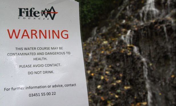 The waterfall at Starley Burn and the warning sign.