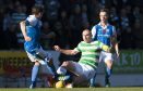 Celtic's Scott Brown challenges St Johnstone's Paul Paton.