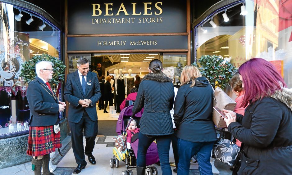 People walking in through door with 'Beales Department Store, formerly McEwens' above door