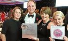 Andy Lothian, CEO Insights Learning & Development, celebrates with Susan Duncan, Brenda Douglas and Jan Anderson