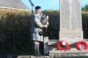 Adam Michie plays the pipers at Almondbank War memorial on Sunday
Pic Phil Hannah