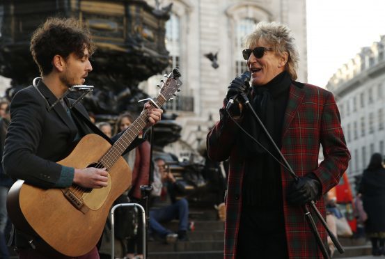 Star Rod Stewart with singer Henry Facey sing a version of "Handbags and Gladrags