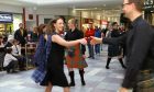 RSCDS members dancing in the busy St. John's Shopping Centre, Perth