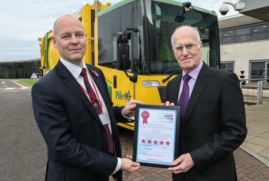 Councillor Ross Vettraino (right) picks up the Eco Stars award - but admits it's going to be challenging for local authorities to meet tough new climate change targets.