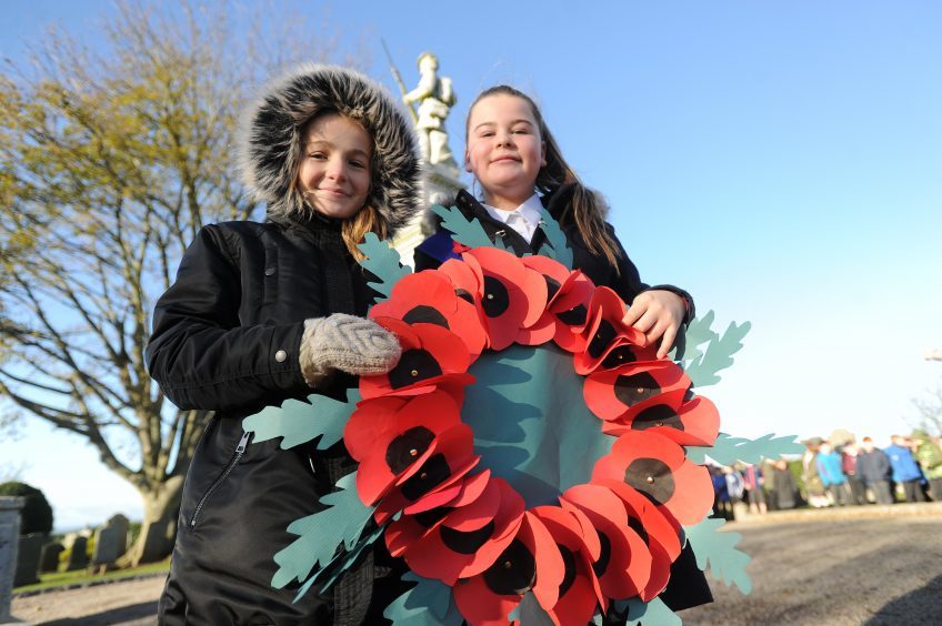 KIRRIEMUIR: Northmuir P7 pupils Rachael Shaw (11) and Sasha Cameron (11) with the wreath they were to lay at Kirriemuir War Memorial.