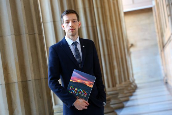 John Alexander, Leader of Dundee City Council with the Dundee 2023 bid brochure.