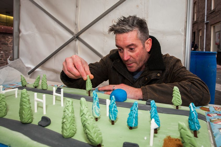 Radio DJ Stuart Webster with his cake based on the North Inch.