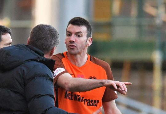 Paul Quinn gets instructions from manager Csaba Laszlo.