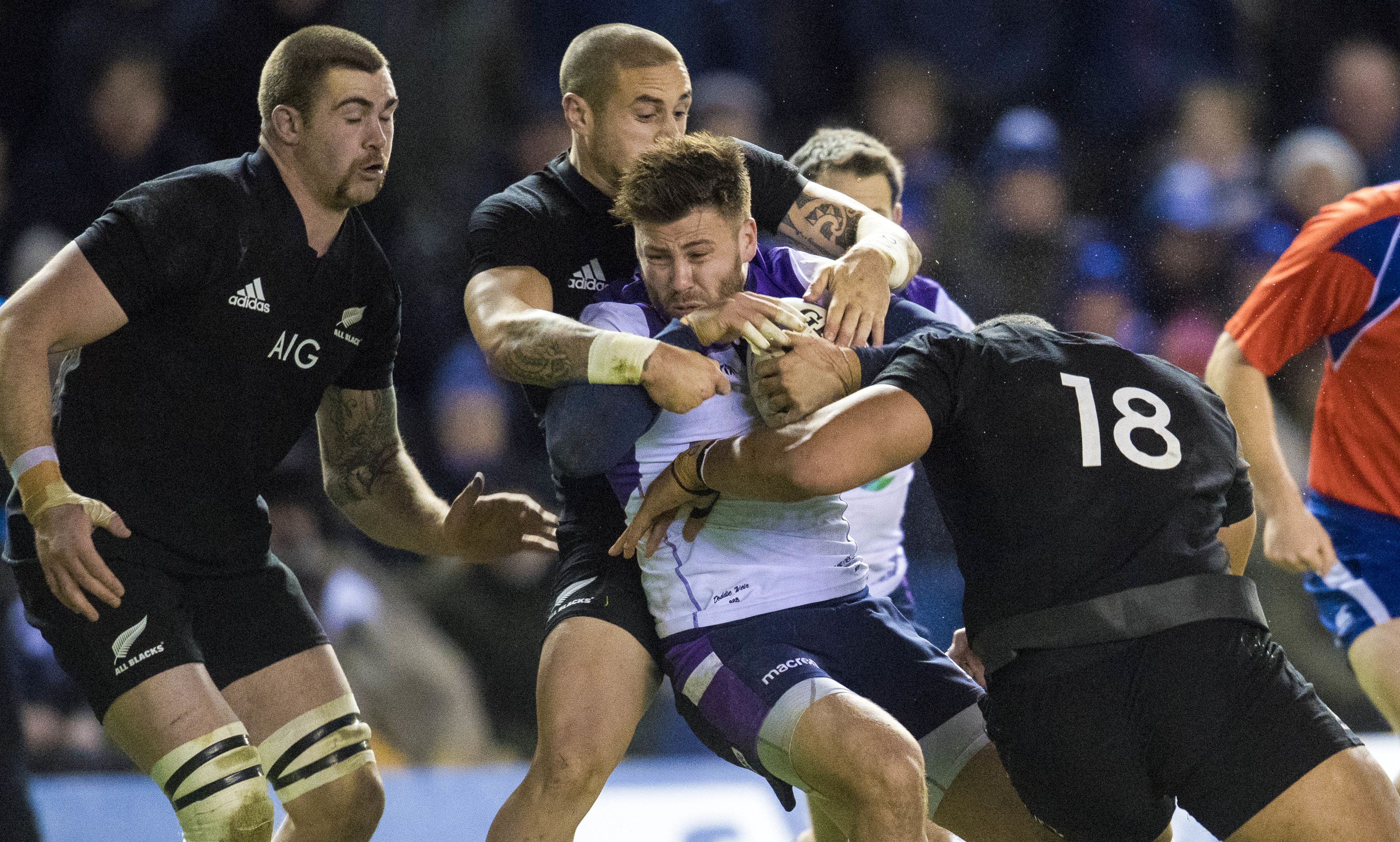 "Little guy" Ali Price battles through three All Blacks during the game at Murrayfield.