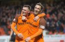 Scorer Jamie Robson is congratulated by Scott McDonald after United's second