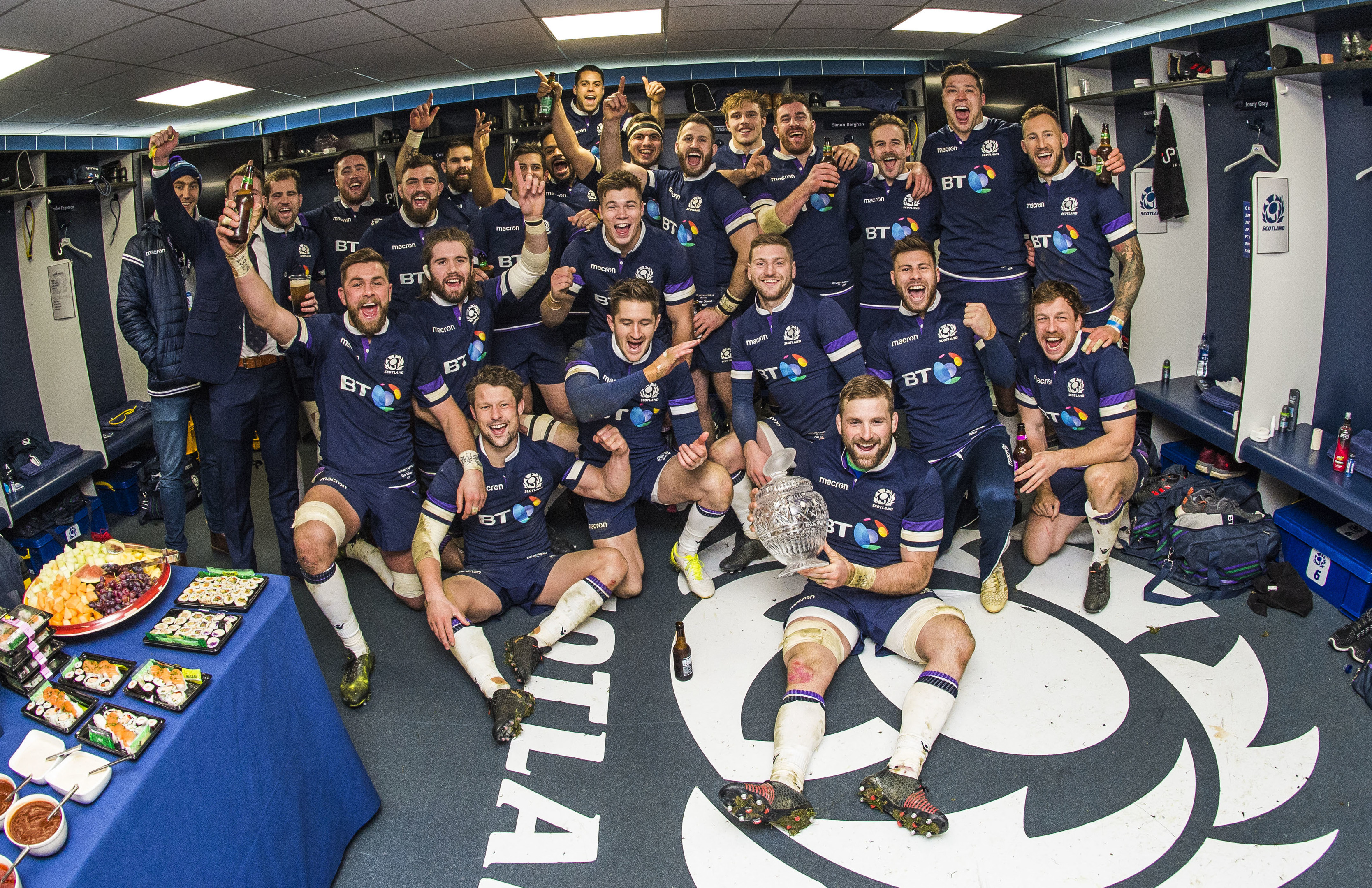 The Scotland players celebrate in the dressing room after their record win over Australia.
