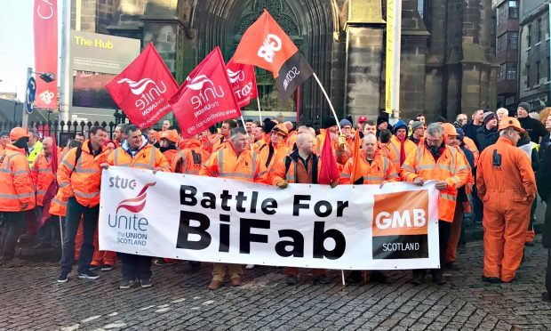 The workers assemble ahead of the march to the Scottish Parliament.