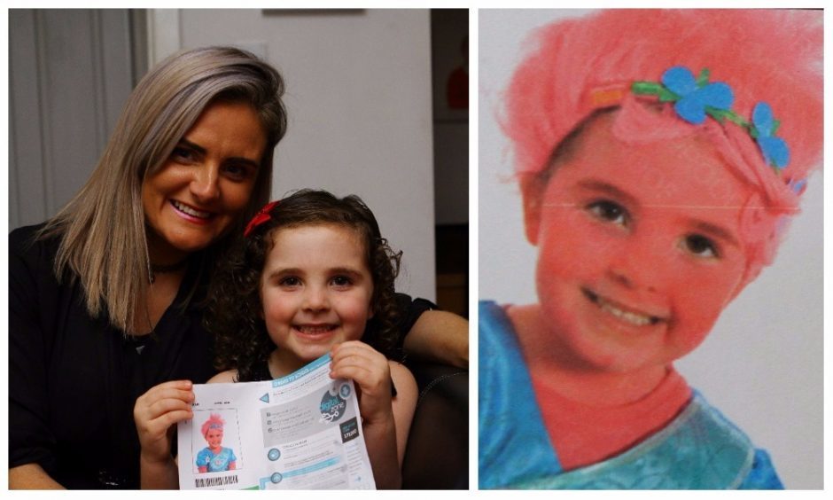 Scarlett Campbell with mum Lisa and a copy of the photo she had taken in her Halloween costume.