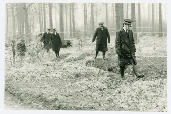 Police search Templeton Woods after the murder of Carol Lannen.