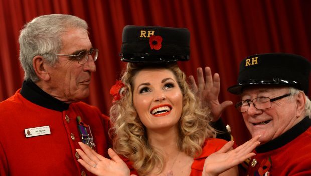 Amy Hawthorn  tried on a Chelsea Pensioners Cap supplied by Staff Sergeant Bill Bullick ,70, and Col Sergeant John Nicoll, 74, ex Black watch at Dundee.