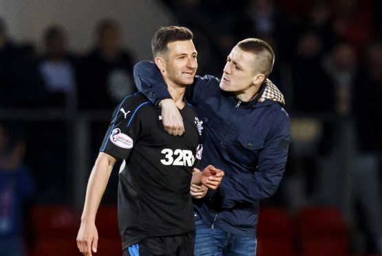 Redmond with Rangers player Jason Holt during his pitch invasion