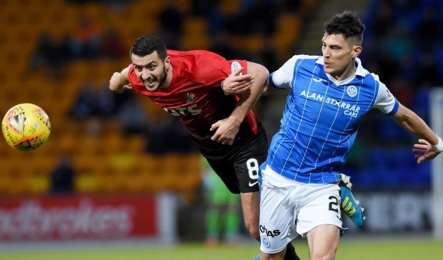 St Johnstone's Graham Cummins and Killie's Gary Dicker contest the ball.