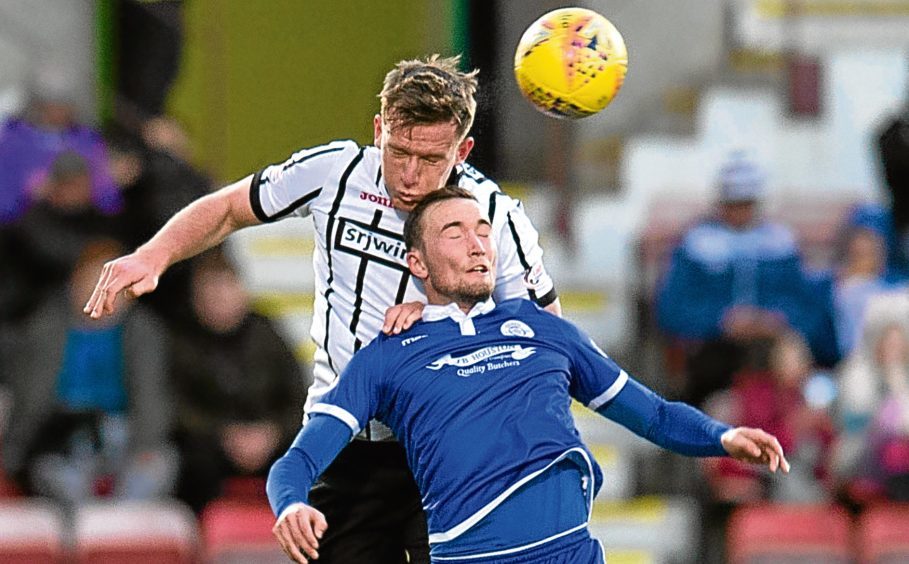 Lee Ashcroft in action for former club Dunfermline Athletic as he rises above Chris Kane to win a header. 