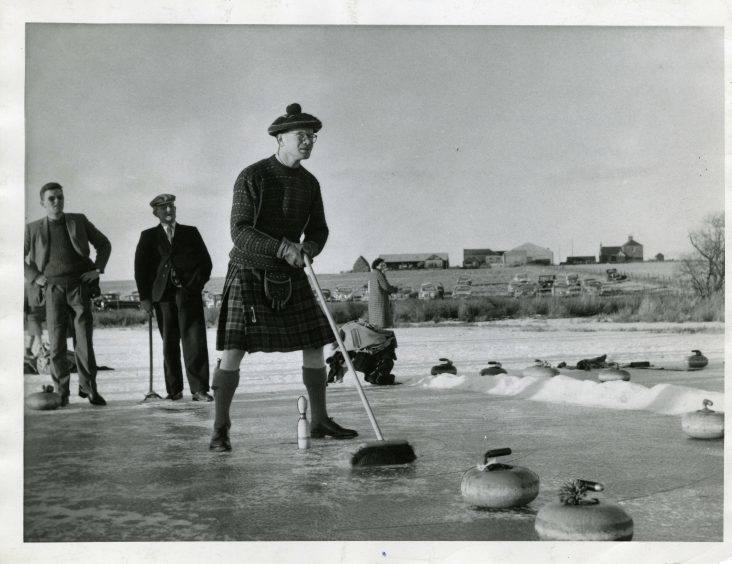 Kilted George Doig, Southesk, in play at the Dun's Dish Bonspiel. January 1963.