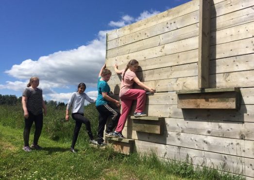 Dens Road Primary school pupils tackle an assault course.