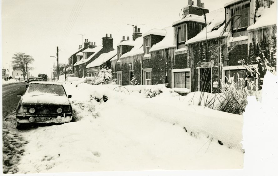Photograph showing the large quantities of snow beside housing at Muirhead after a snow storm in the Dundee area. January 14, 1987.