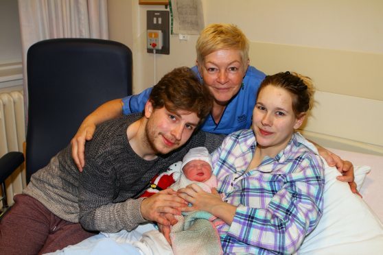 Proud parents Craig Phillip and Brooke Mollison show off their new daughter Tilly, with mid wife Julie Cabrelli.