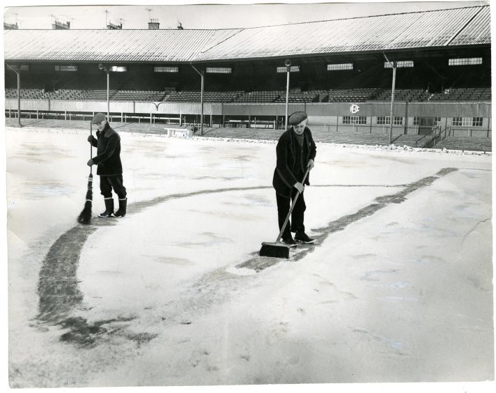 Dens Park in Snow.
Photograph showing two men sweeping snow in Dens Park, Dundee, January 17, 1963.
