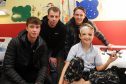 Jack Hendry, Paul McGowan and Scott Allan visiting nine-year-old Marcus Summers.