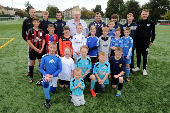 Fair City FC and Letham FC football clubs came together in October 2016. One year on, they are to go their separate ways once more.
Pictured as the merger was announced are 
youngsters and coaches from each of the clubs with Letham's then president Ken Drummond (who sadly died this year) and Secretary Jon Kidd.