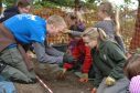 PKHT outreach officer Gavin Lindsay and AOC Archaeologist Katie Roper teaching P6 pupils from Royal School of Dunkeld how to dig and identify artefacts at the fort.