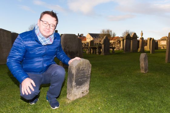 Roger McStravick with the existing gravestone erected following the death of Jamie Anderson's son.