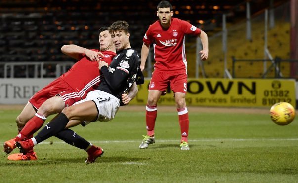 Scott McKenna, left, scores for Aberdeen.