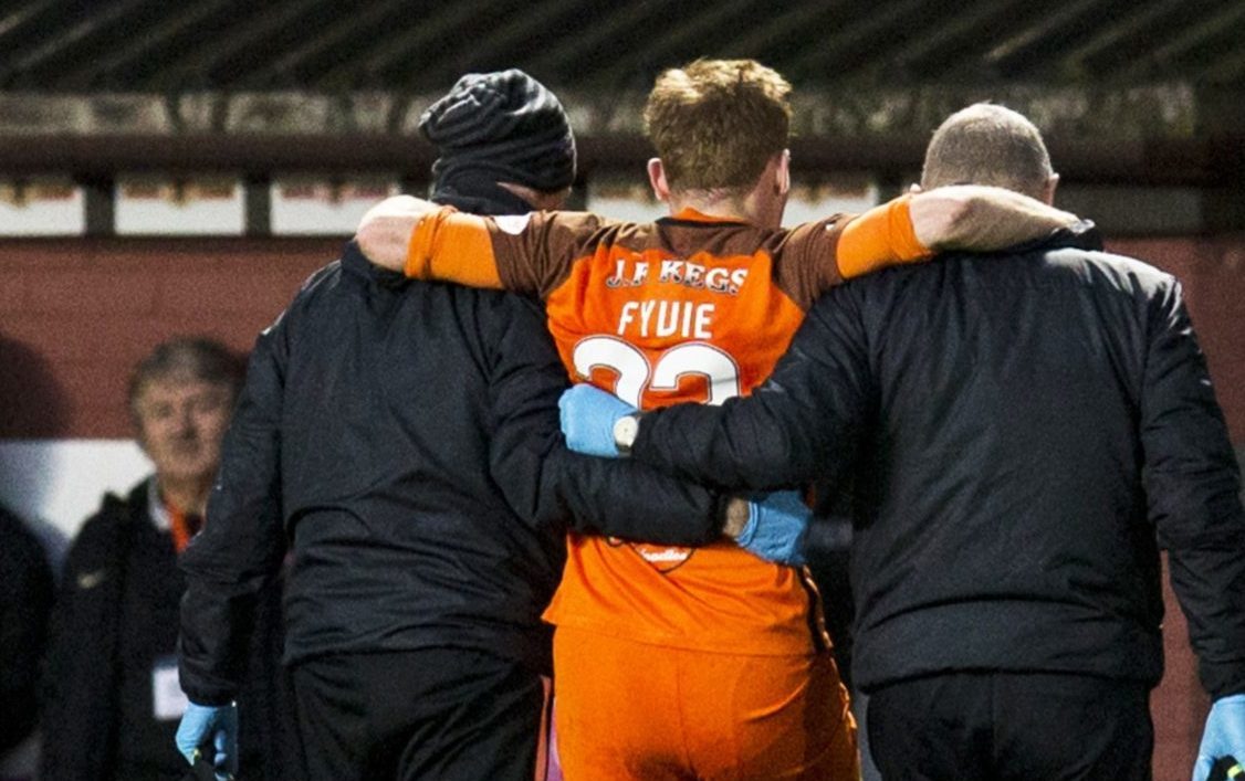 Fraser Fyvie is helped from the pitch.