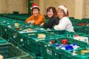 Bank of Scotland employees Kim McGill and Margaret Stanford with Pauline Buchan, centre during last year's deliveries.