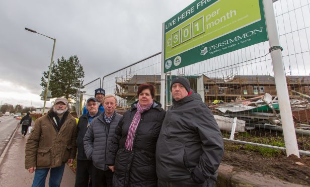 Councillor Willie Robertson in the centre outside the Lathro Meadows site with disgruntled locals.