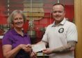 Pam Smith, captain of Crail Golfing Society, presents a cheque for £1000 to David Gillies, representing St Andrews Legacy, a charity that helps ill and injured military veterans towards recovery through golf.