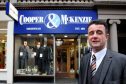 Grant Mitchell outside Cooper and McKenzie to celebrate its 140th anniversary in 2014.
