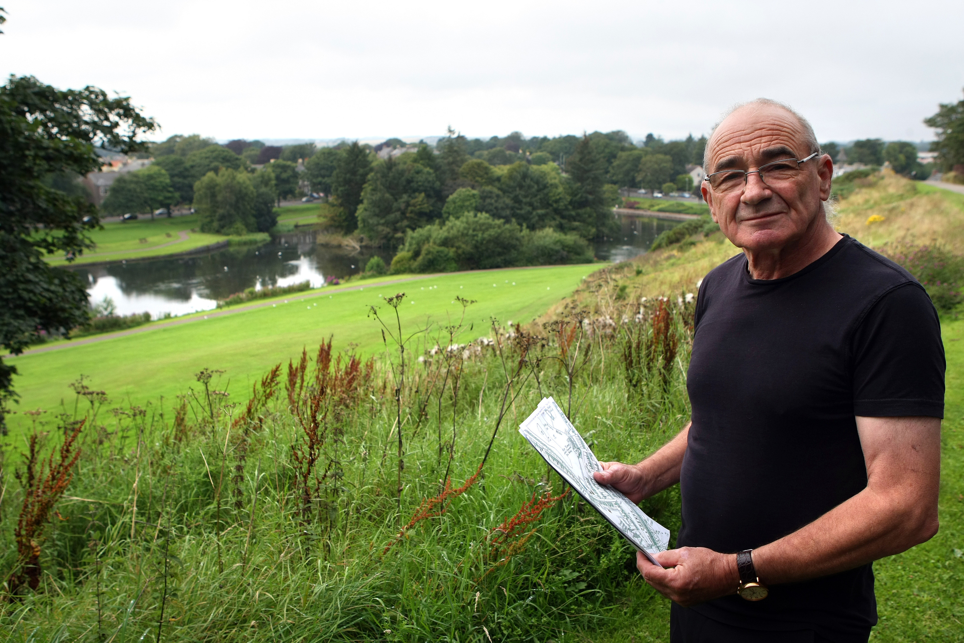 Former town planner George Park looking at the pond.