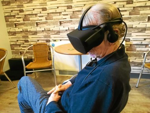 An older person trying a virtual reality headset.