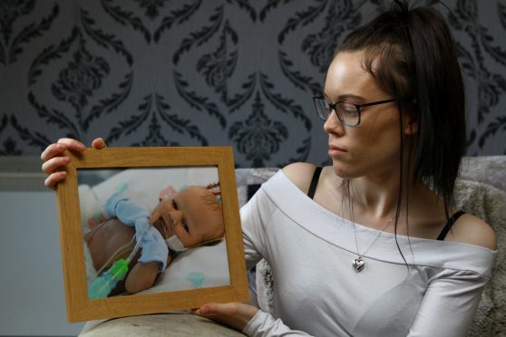 Maria Strachan  with a photo of her son Ethan