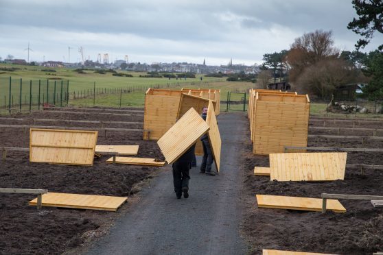 Workmen install sheds and water bowsers in the once-neglected Silverburn Park.