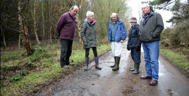 Councillor Miklinski, left, and local residents examine the state of the road at Blebo Craigs