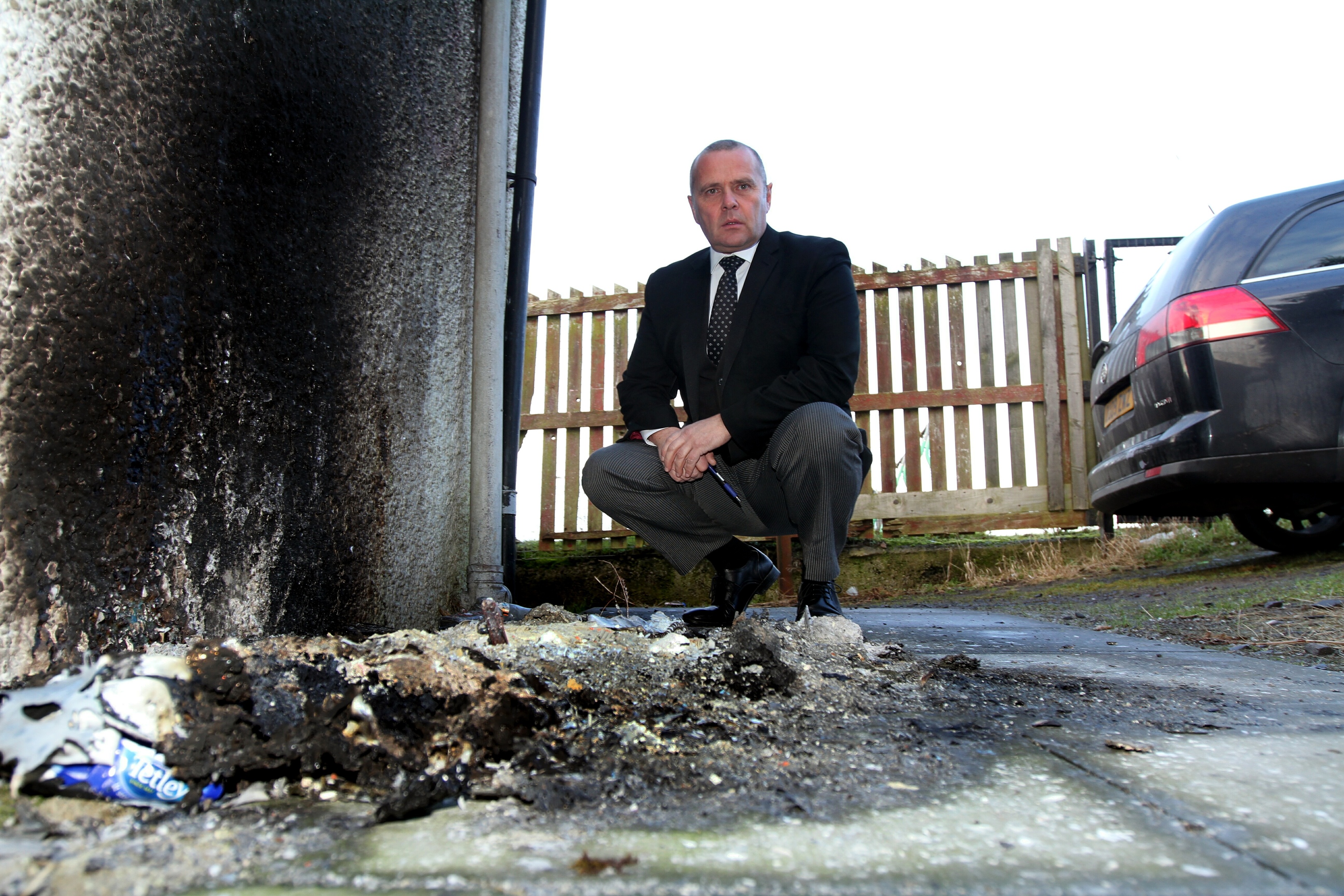 Paul Craigie with the remains of the wheelie bin outside Affertons Funeral Care.
