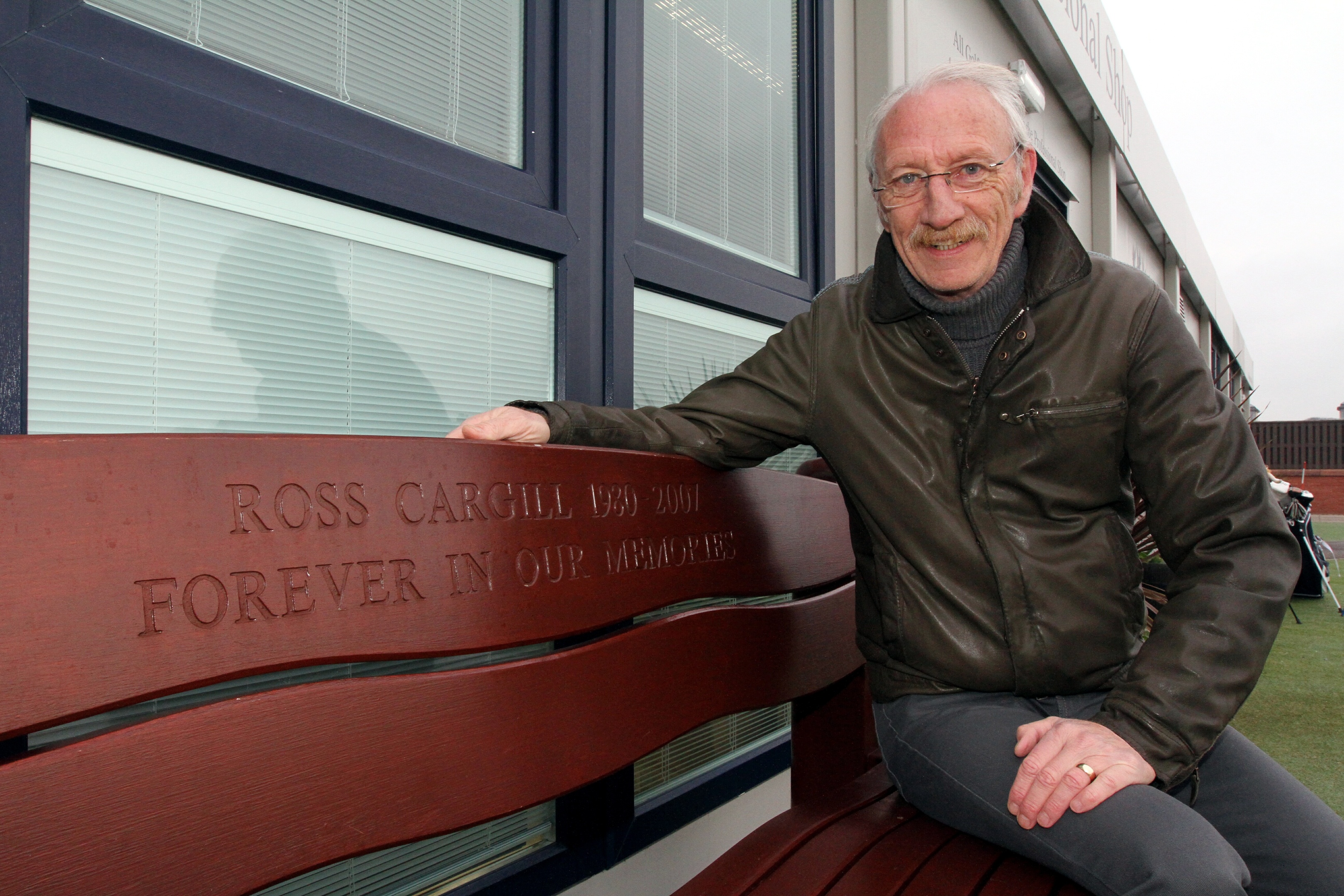 Neill pictured at a bench dedicated to Ross outside the pro shop at Carnoustie Links Golf Centre.