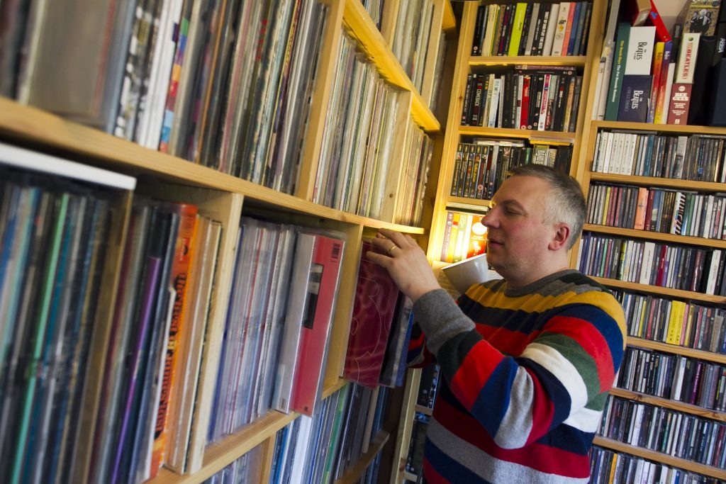 Jan Burnett browses his 12,500 strong music collection at home in Glasgow